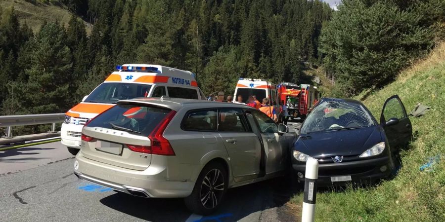 Die beiden verunfallten Fahrzeuge stehen am Strassenrand. Dahinter sind zahlreiche Einsatzkräfte im Einsatz.