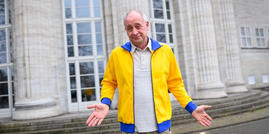 Der deutsch-französische Kabarettist und Satiriker Emmanuel Peterfalvi alias Alfons zeigt sich mit seiner nun aus Solidarität für die Ukraine gelb-blauen Trainingsjacke.