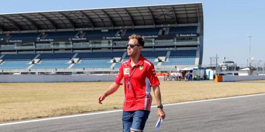 Sucht in diesem Jahr noch die Ideallinie: Ferrari-Pilot Sebastian Vettel. Foto: Jan Woitas
