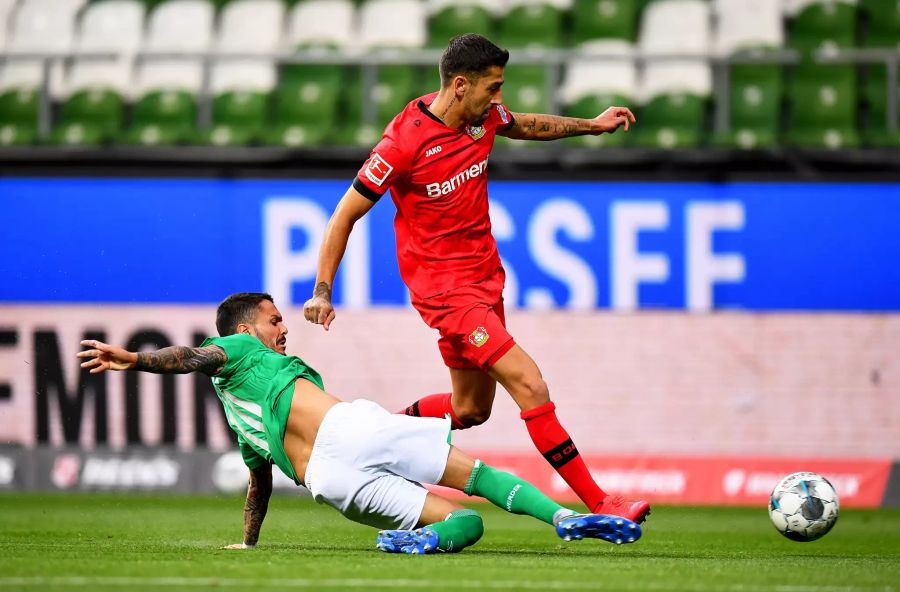 Werders Leonardo Bittencourt (l.) setzt gegen Leverkusens Kerem Demirbay (r.) zur Grätsche an.