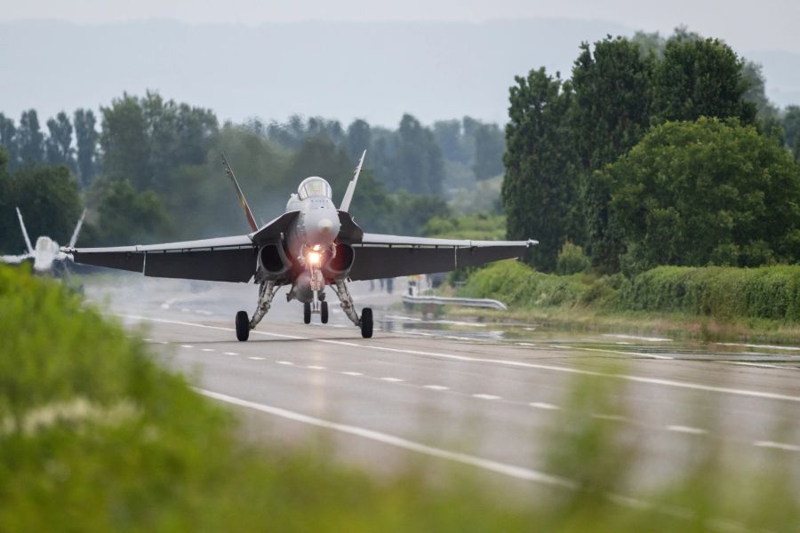 Zwischen Landwirtschaft und Gehölz: Zwei F/A-18 auf der Autobahn A1 bei Payerne VD,