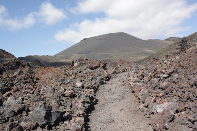 Auf der kanarischen Insel La Palma kann man wandernd vulkanische Landschaften durchstreifen. Vulkanlandschaft Wanderweg Steine Lava