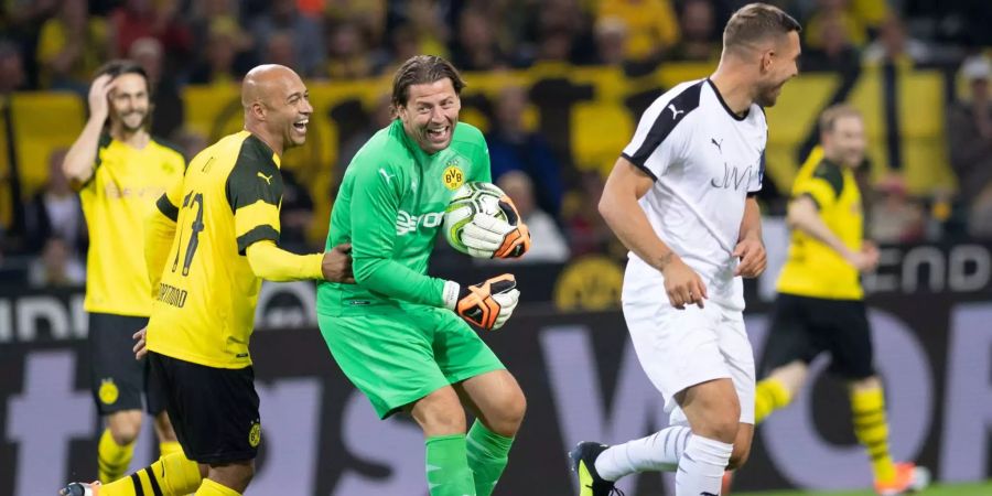 Roman Weidenfeller (M) freut sich über eine Parade bei einem von Lukas Podolski (r) geschossenen Elfmeter zusammen mit Dede (l).