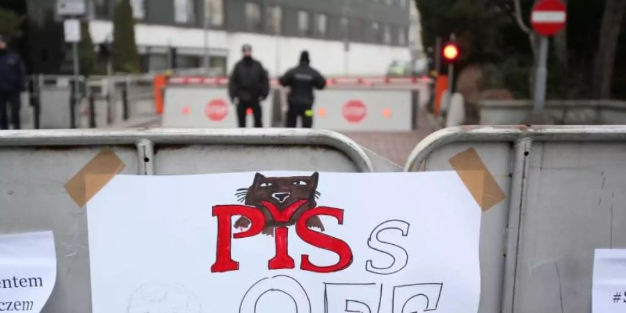 "Piss Off" steht auf einem Zettel, der während einer Demonstration gegen eine Einschränkung der Pressefreiheit 2016 an einem Schild in Warschau hängt. (Archivbild). Foto: Leszek Szymanski/PAP/dpa