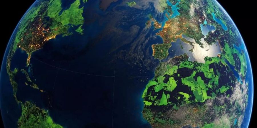 Visualisierung der Erde: Die grün dargestellten Flächen markieren laut der Studie diejenigen Gebiete, die unter Schutz gestellt werden müssten, um das Artensterben zu begrenzen und wirkungsvollen Klimaschutz zu leisten. Foto: Felix Pharand-Deschenes/Globaia/dpa