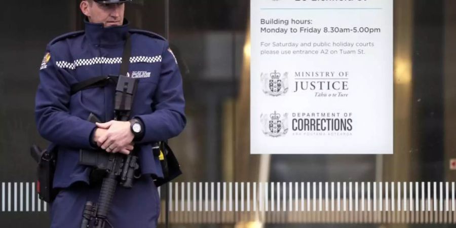 Ein Polizist steht vor dem Eingang zum Gericht in Christchurch. Der mutmassliche Attentäter wurde bei einer Anhörung per Video-Übertragung zugeschaltet. Foto: Mark Baker/AP