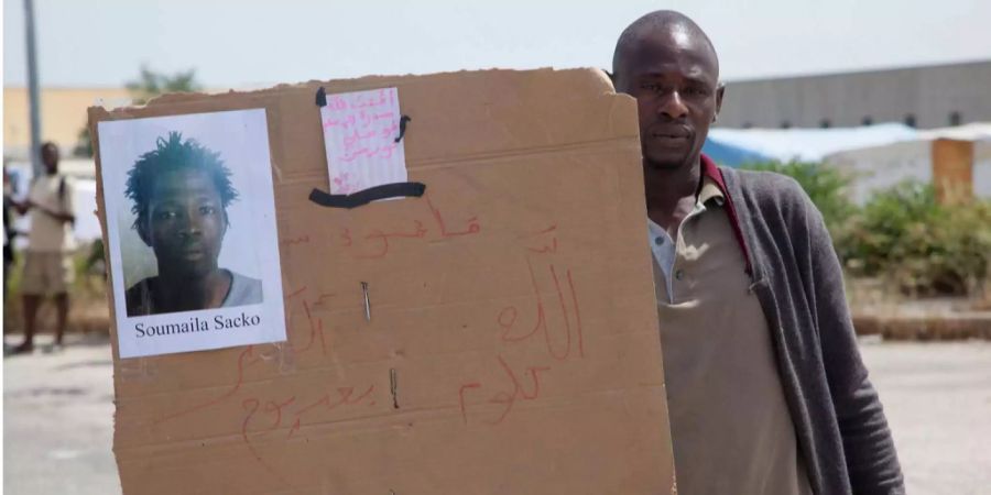 Dutzende Arbeiter demonstrieren gegen Unterdrückung und Fremdenhass. Auf ihren Plakaten tragen sie Bilder des erschossenen Soumaila Sacko.