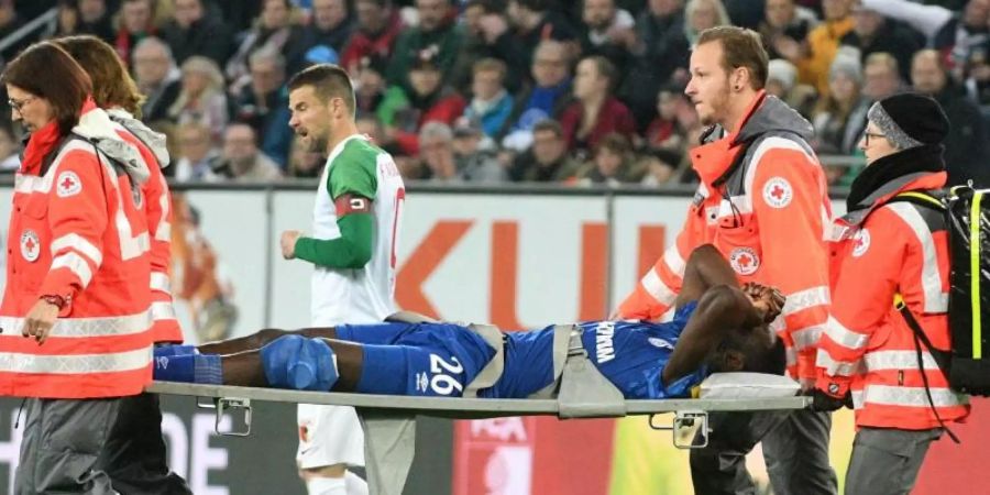 Schalkes Salif Sane wird verletzt vom Platz getragen. Foto: Stefan Puchner/dpa