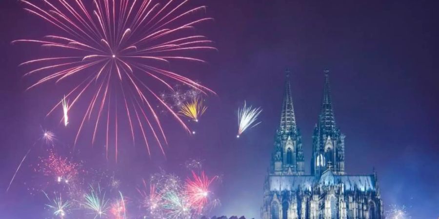 Feuerwerk ist am Rhein über dem Kölner Dom zu sehen. Foto: Christophe Gateau/dpa