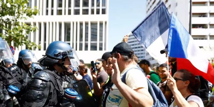 Bei einer Protestveranstaltung gegen die verschärfte Nachweispflicht stehen sich in Paris Demonstranten und Polizisten gegenüber. Foto: Sameer Al-Doumy/AFP/dpa Bei einer Protestveranstaltung gegen die verschärfte Nachweispflicht stehen sich in Paris Demonstranten und Polizisten gegenüber. Foto: Sameer Al-Doumy/AFP/dpa