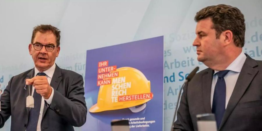Die Bundesminister Gerd Müller (CSU, l) und Hubertus Heil (SPD) wollen Unternehmen noch in dieser Legislaturperiode mit einem Gesetz zur Einhaltung von Menschenrechten in den Lieferketten verpflichten. Foto: Michael Kappeler/dpa