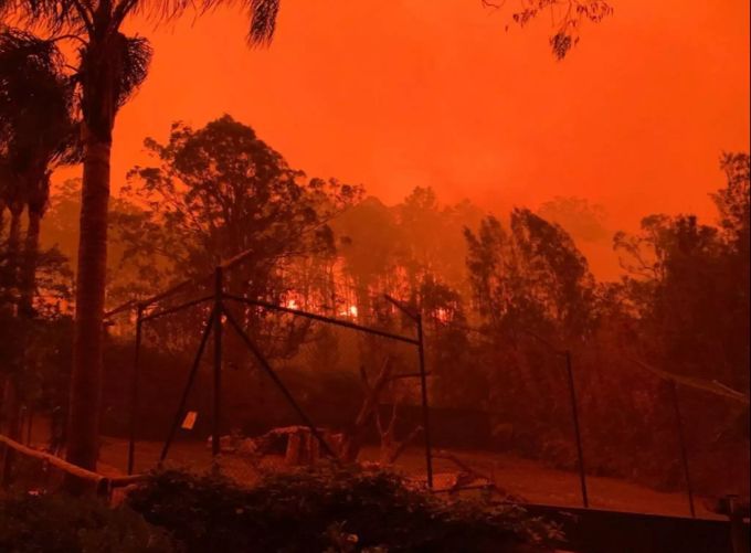 Feuerroter Himmel über einem Gehege des Mogo Wildlife Parks. feuer