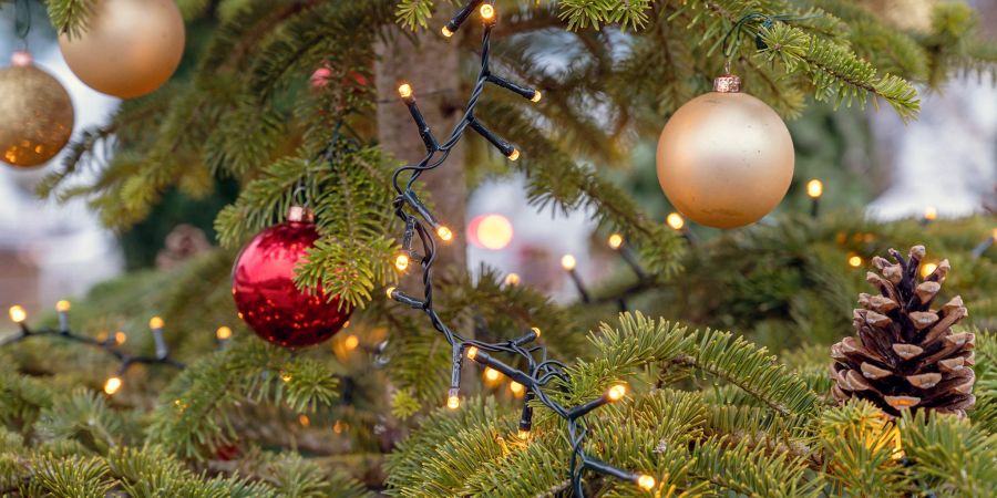 Ein mit Kugeln und elektrischen Lichtern geschmückter Weihnachtsbaum. (Symbolbild)