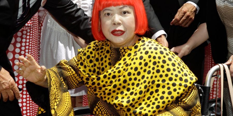 ARCHIV - Die japanische Künstlerin Yayoi Kusama winkt vor den Schaufenstern des Vuitton-Flagship-Stores anlässlich der Enthüllung einer neuen gemeinsamen Kollektion von Kusama und de...