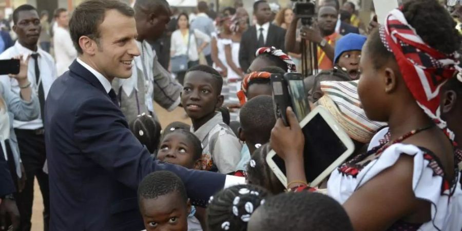 Emmanuel Macron, Präsident von Frankreich, in Burkina Fasos Hauptstadt. Er hat 2017 die Rückgabe von Kolonialkunst versprochen. Foto: Ahmed Yempabou Ouoba/AP