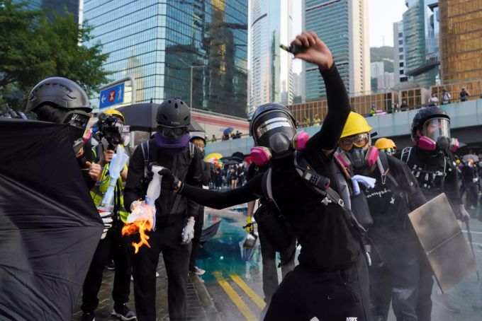 Ein Demonstrant wirft bei einer Anti-Regierungs-Demontration in der Nähe des Regierungsgebäudes einen Molotow-Cocktail. Proteste in Hongkong
