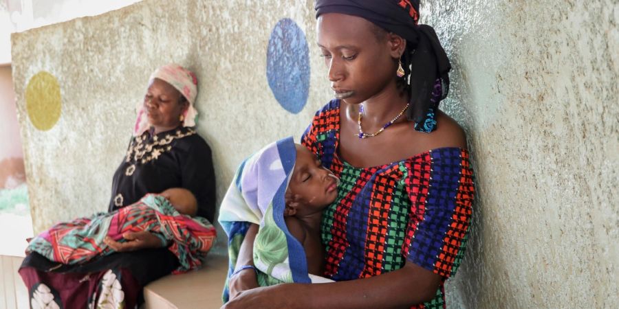 Burkina Faso: Eine Mutter (r.) hält ihren zweijährigen Sohn, der wegen Unterernährung mit einer Magensonde behandelt wird.