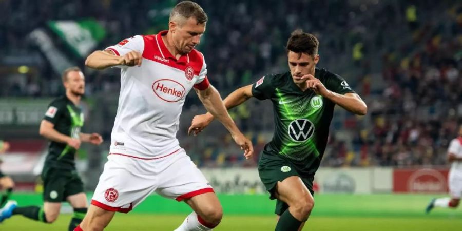 Düsseldorfs Oliver Fink (l) und Wolfsburgs Josip Brekalo kämpfen um den Ball. Foto: Marius Becker
