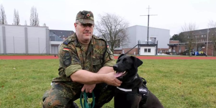 Hauptfeldwebel Alexander Schmidt von der Logistikschule der Bundeswehr in Garlstedt hat Therapiehund «Krümel» an der Leine. Foto: Marine