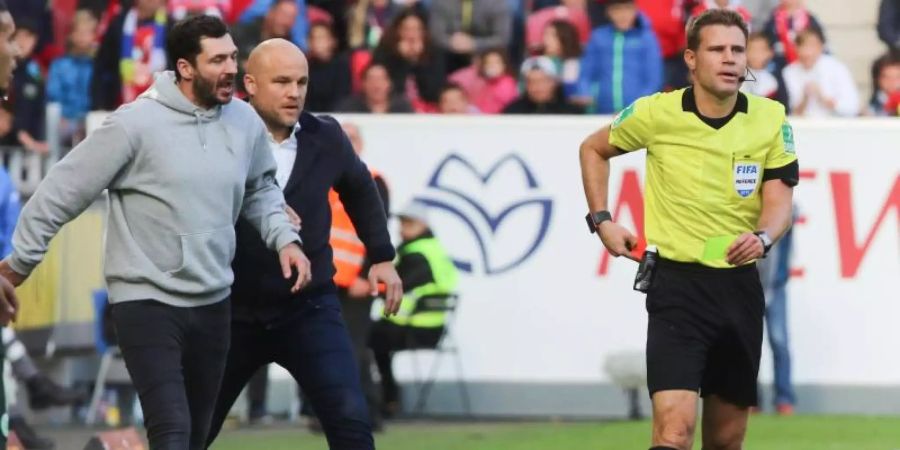 Der Mainzer Trainer Sandro Schwarz beschwert sich bei Schiedsrichter Felix Brych. Foto: Frank Rumpenhorst