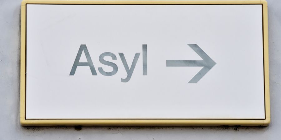ARCHIV - Ein Schild mit der Aufschrift «Asyl» hängt an einer Wand. Foto: Uli Deck/dpa