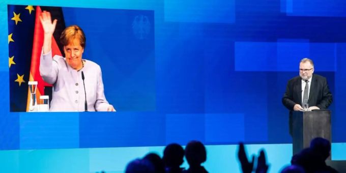 Die per Video live zugeschaltete Bundeskanzlerin Angela Merkel (CDU) verabschiedet sich nach ihrer Reder beim Tag der deutschen Industrie des Bundesverbandes der Deutschen Industrie (BDI). Foto: Bernd von Jutrczenka/dpa Die per Video live zugeschaltete Bundeskanzlerin Angela Merkel (CDU) verabschiedet sich nach ihrer Reder beim Tag der deutschen Industrie des Bundesverbandes der Deutschen Industrie (BDI). Foto: Bernd von Jutrczenka/dpa