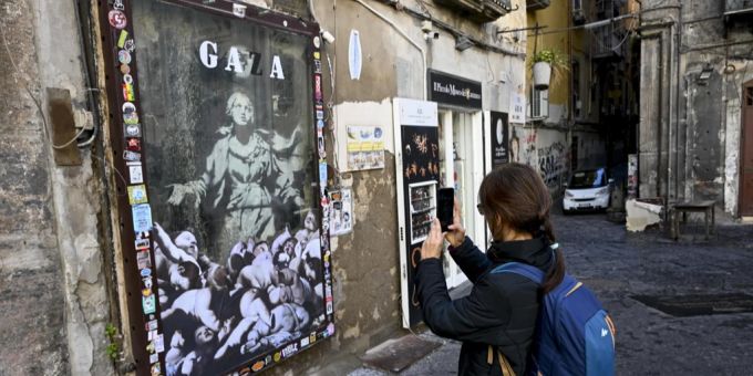 Eine Person betrachtet das Gemälde «Madonna with the gun» von Banksy. banksy identität
