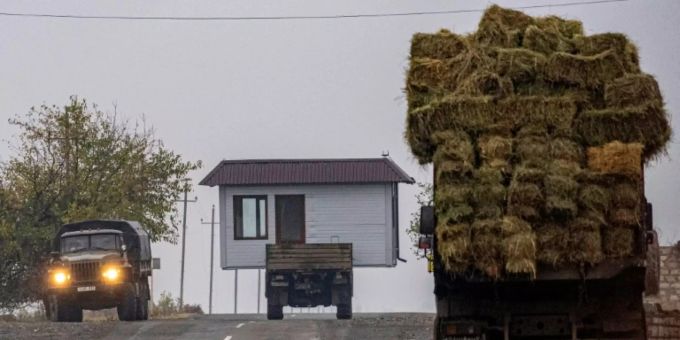 A truck carries a barn as Armenian refugees leave the village of Nor Maragha near Agdam
