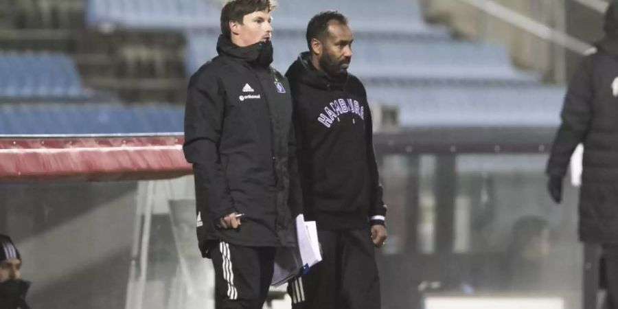 Co-Trainer Merlin Polzin (l) und der HSV-Trainer Daniel Thioune beobachten das Spiel. Foto: Frank Molter/dpa