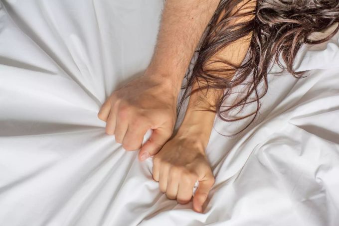 Heute ist Weltorgasmustag. Hand von Mann und Frau
