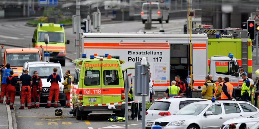 Einsatzfahrzeuge der Polizei und Feuerwehr stehen vor einem ausgebrannten Gebäude am Bahnhofsplatz in der Nähe des Hauptbahnhofs.