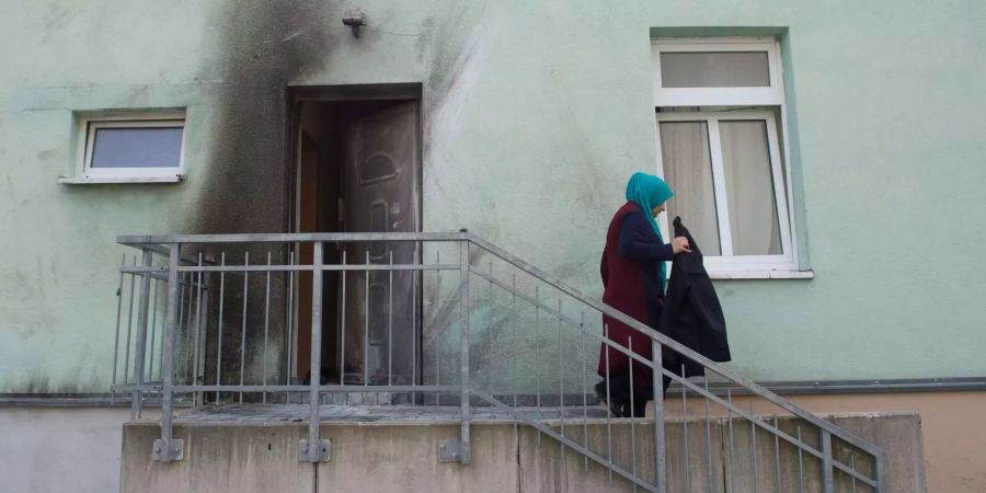 Eine Frau verlässt nach einem Sprengstoffanschlag die Fatih Camii Moschee in Dresden.