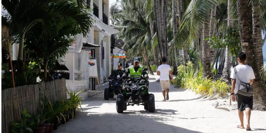 Polizisten patrouillieren auf der Insel.