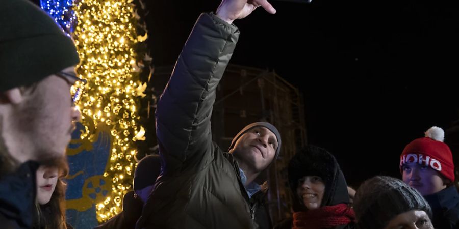 Bei der Einweihung eines Weihnachtsbaumes in Kiew macht Bürgermeister Vitali Klitschko ein Selfie mit Unterstützern. Foto: Vasilisa Stepanenko/AP/dpa