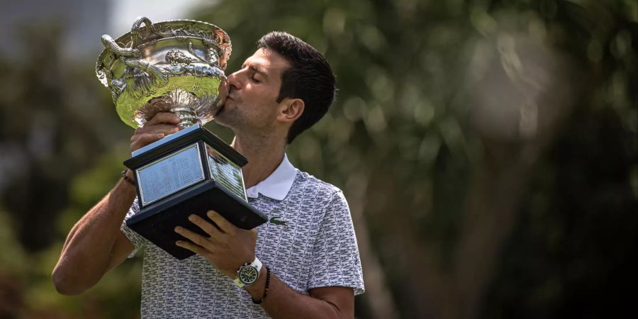 Novak Djokovic küsst den Pokal der Australian Open.