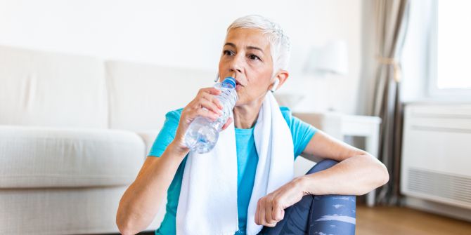 Frau trinkt Wasser nach dem Sport