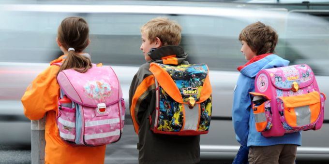 Ängstliche Eltern legen ihren Kinder manchmal GPS-Geräte wie Airtags in den Rucksack. (Symbolbild) Schulkinder mit Rucksack