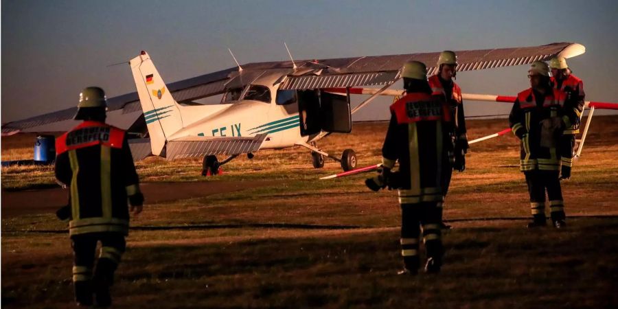 Rettungskräfte schreiten zur kaputten Cessna nach dem Absturz.