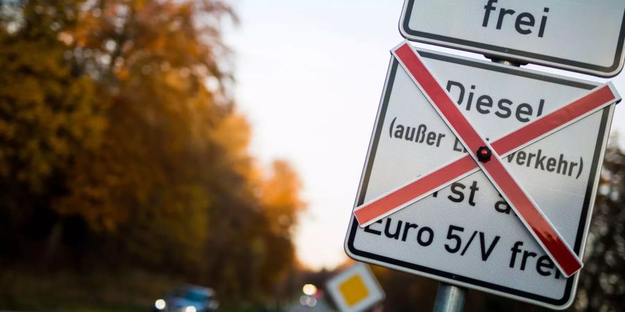 Schilder an einer Strasse weisen auf geplante Fahrverbote hin.