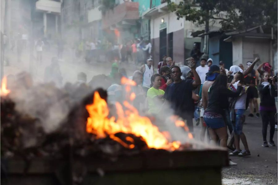 Venezolaner protestieren zur Unterstützung einer Meuterei von Nationalgardisten gegen die Regierung vom Präsidenten Maduro.