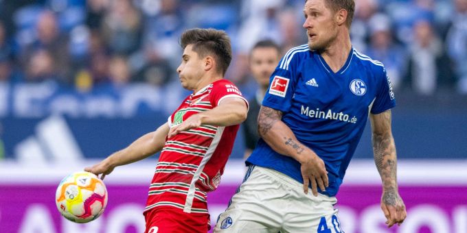 Der Augsburger Elvis Rexhbecaj (l) im Zweikampf mit dem Schalker Sebastian Polter. Der Augsburger Elvis Rexhbecaj (l) im Zweikampf mit dem Schalker Sebastian Polter.