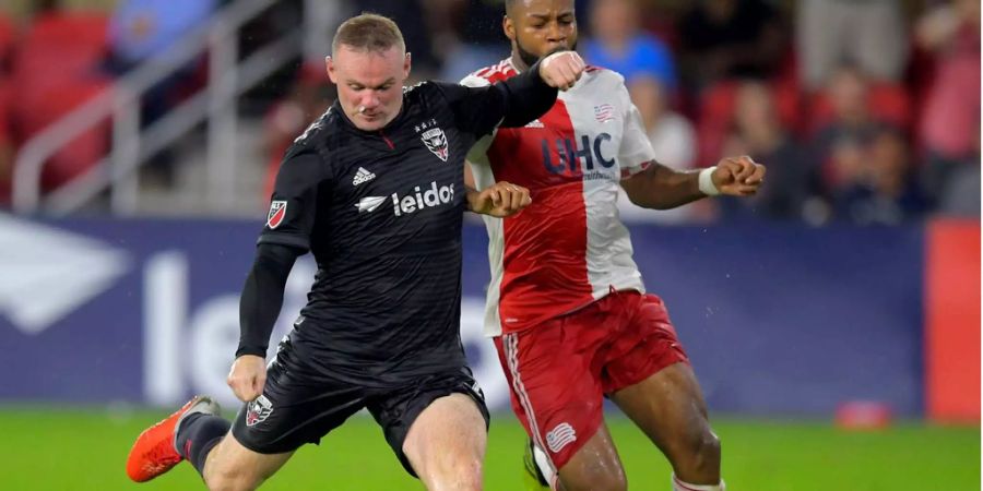 Wayne Rooney (links, DC United) setzt gegen Andrew Farrell (New England Revolution) zum Schuss an (Archivbild).