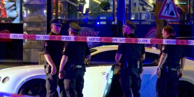 Polizisten stehen neben dem Auto des Rockerbosses auf dem Millerntorplatz an der Reeperbahn, nachdem die Schüsse gefallen waren. Foto: Mücahid Güler/dpa Polizisten stehen neben dem Auto des Rockerbosses auf dem Millerntorplatz an der Reeperbahn, nachdem die Schüsse gefallen waren. Foto: Mücahid Güler/dpa