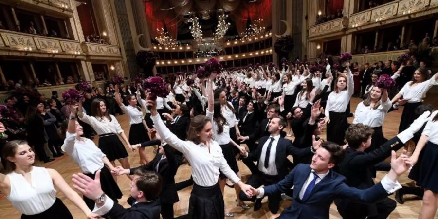 Debütantenpaare tanzen in der Wiener Staatsoper während der Generalprobe. Foto: Helmut Fohringer/APA/dpa