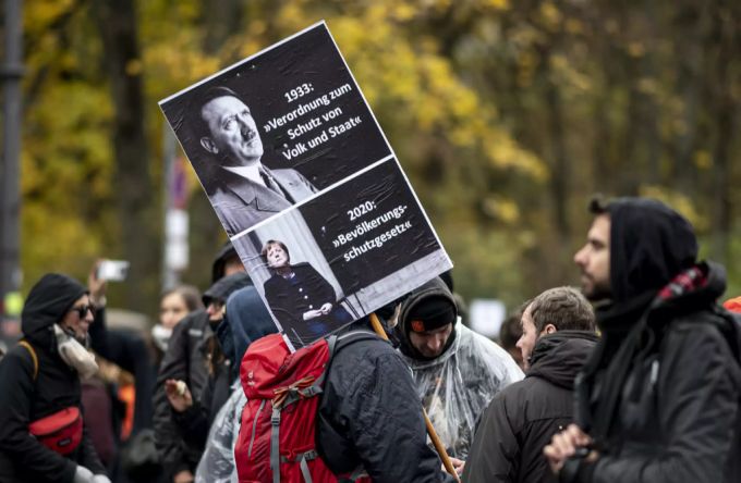 Berlin, November 2020: Ein Corona-Skeptiker vergleicht das «Bevölkerungsschutzgesetz» mit einem Gesetz von Hitler. Hitler Merkel Coronavirus Demonstration