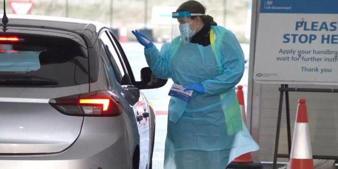 Eine Medizinerin entnimmt einem Bürger eine Probe auf dem Corona-Testgelände am Flughafen Edinburgh. Foto: Andrew Milligan/PA Wire/dpa Eine Medizinerin entnimmt einem Bürger eine Probe auf dem Corona-Testgelände am Flughafen Edinburgh. Foto: Andrew Milligan/PA Wire/dpa