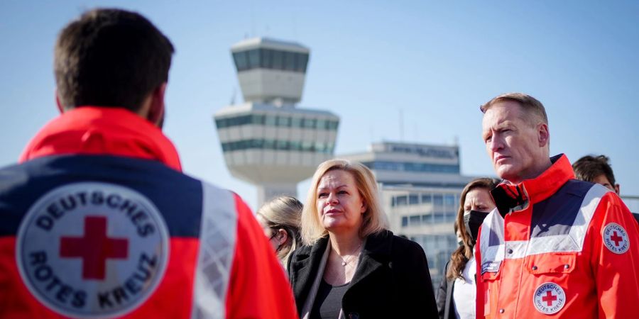 Bundesinnenministerin Nancy Faeser (SPD) und Christian Reuter, Generalsekretär des Deutschen Roten Kreuzes, besichtigen Notunterkünfte für Geflüchtete auf dem Gelände Berlin-Tegel.