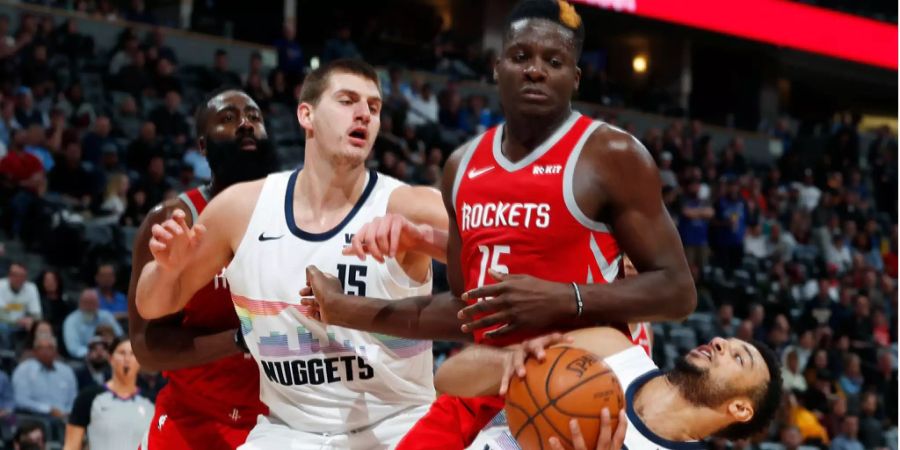 Clint Capela von den Houston Rockets (Mitte) im Duell mit zwei Spielern der Denver Nuggets.