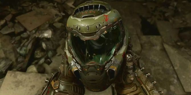 Doomslayer hält seinen Helm in den Händen. Er steht auf einem kaputten Betonboden.