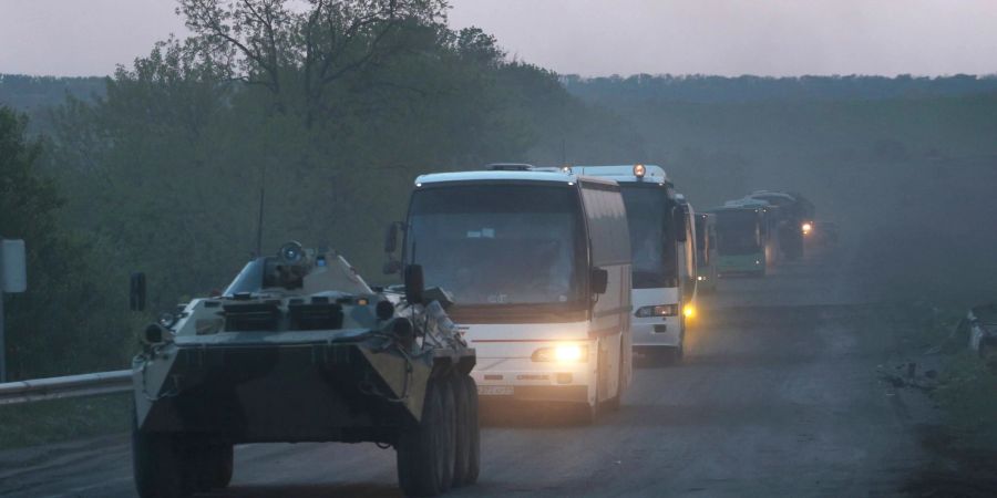 Ein APC der Miliz der sogenannten Volksrepublik Donezk begleitet Busse mit ukrainischen Soldaten zur Strafkolonie in Oljoniwka, nachdem sie das belagerte Stahlwerk Azovstal in Mariupol verlassen haben.